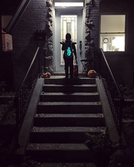 Child makes trick or treat with pumpkins on halloween