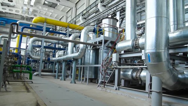 Equipment, cables and piping as found inside of industrial power plant. Scene. Inside a huge gas industry plant