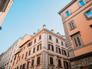 Beautiful facade of apartment building in Rome, Italy. Windows with shutters.