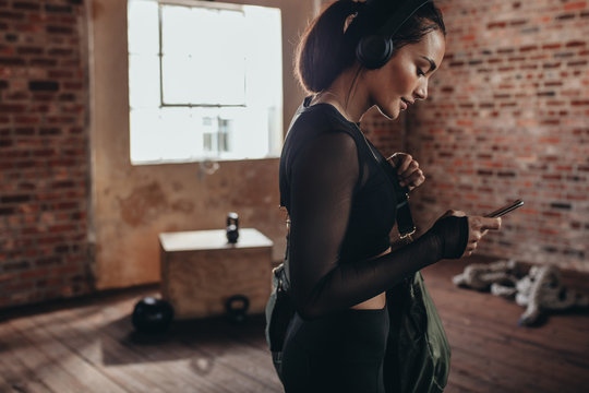 Fitness woman at gym with phone