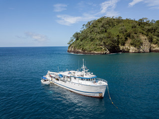 Fototapeta na wymiar Drone view on a boat at Cocos Island