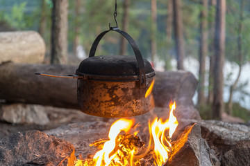 metal pot over a fire