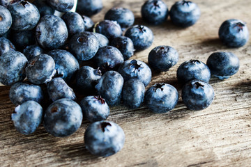 Blueberries on old wooden table.