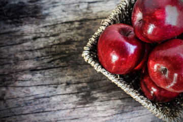 Red apples on old wooden table