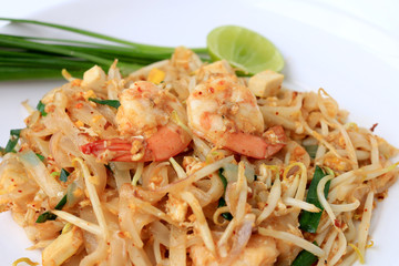 Thai style noodles, Pad Thai, stir-fried rice noodles with shrimp serve with vegetable in white plate on white background. The one of Thailand's national main dish. the popular food in Thailand.