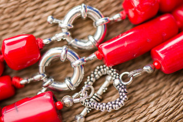 Silver clasp on a red coral stone and crystal necklace. Beautiful, polished gemstones on natural...