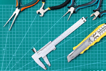 Still life with tools for handmade on the work pad.