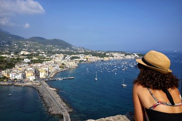 tourist woman admires ischia panorama - obrazy, fototapety, plakaty