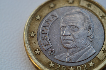 Coin one euro on a white textured backdrop background. Close-up view.