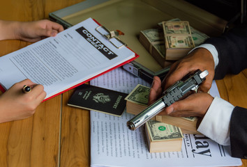Criminals use gun threats and money bribes To let others sign a contract, for their own benefit, to...