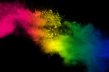 Color powder explosion.Colorful dust splash isolated on black background.