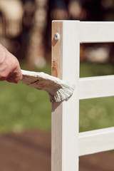 Old man paint his new bed on terrace
