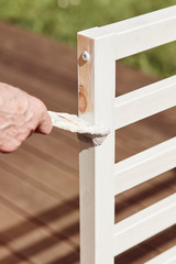 Old man paint his new bed on terrace