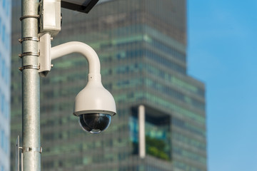 Modern CCTV camera on the metal pole concept or surveillance and monitoring with blue sky background