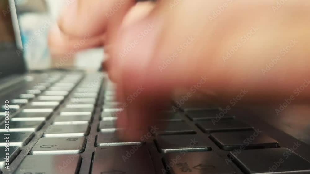 Poster hands typing fast on laptop keyboard.
