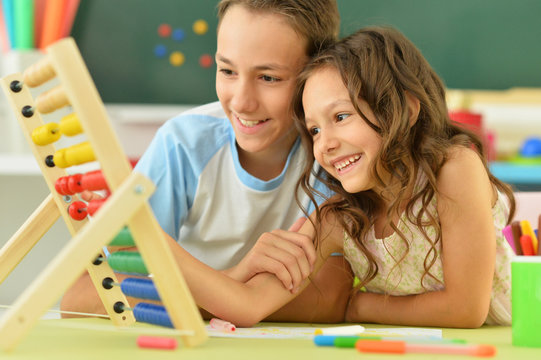 Portrait of a little girl counting on abacus