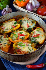 Stuffed halves of bell peppers with mince and cheese in a frying pan. European and Caucasian cuisine meal