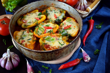 Stuffed halves of bell peppers with mince and cheese in a frying pan. European and Caucasian cuisine meal