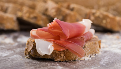sandwich made with rye bread cheese and Parma ham
