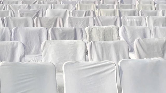 Sitting with white covers in the meeting room of the religious community, empty seats. India
