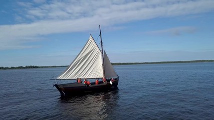 ARIEAL: Flight over small wodden sailingboat on the sea