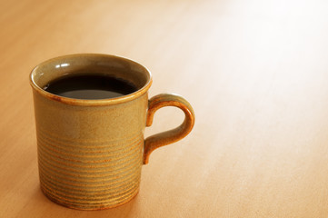 Cup of black coffee on the table