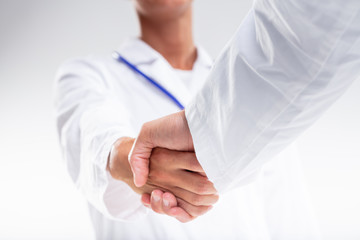 Two medical doctors shaking hands
