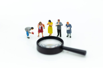 Miniature people: Students read books with magnifying glass . Image use for education concept.