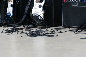 The guitar is located in the center of the concert hall. And amplifiers, power cord.