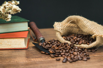 Cup of coffee, bag and scoop on old rusty background