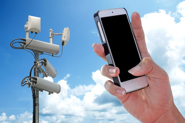 Cellular network antenna and handphone and blue sky.