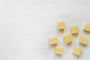 Ingredients for snacks, cheese on a white table with copy space.