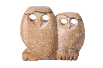 Owls isolated. Two owls handmade of soapstone with holes as eyes isolated on white background.