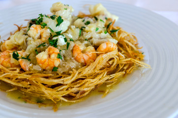 Scrambled eggs with prawns fish and potatoes