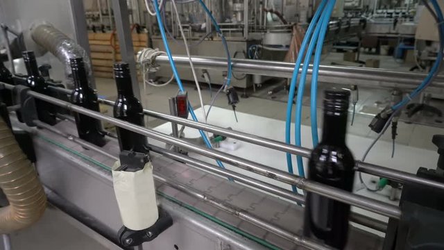 Bottling and sealing conveyor line at winery factory