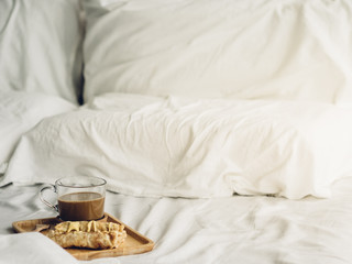 Obraz na płótnie Canvas Breakfast set of Thai sweet roti and hot cocoa served on bed.