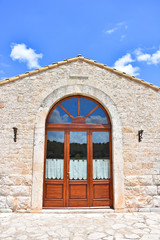 Italy, Puglia region,  view and detail of typical fortified farmhouses spread in the high Murgia area with wells, trees, meadows,