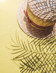 Fototapeta premium Holiday, vacation tropical beach from above - palm tree leaves and a straw hat