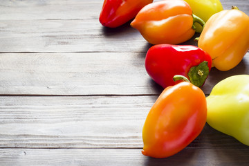 Bright colorful ripe bell pepper on the background of a wooden table.