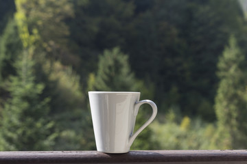 a cup of coffee on the nature in the mountains