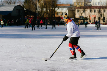 the man plays hockey on the rink