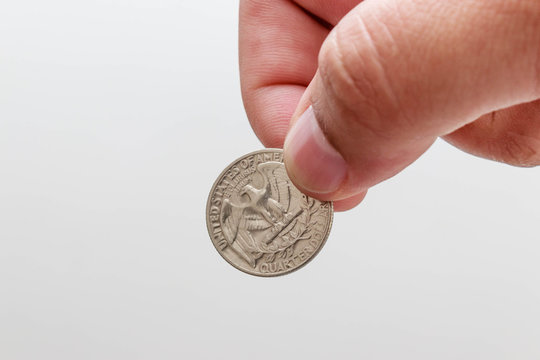 Male Hand Holding Quarter Dollar Coin, White Background