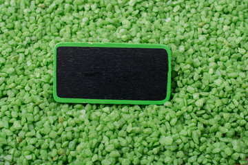 Noticeboard with frame on green color sand