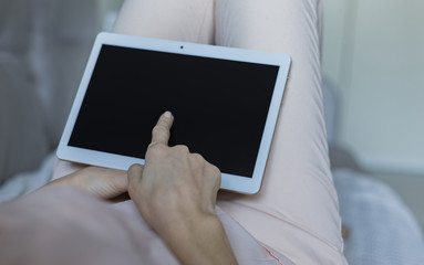 Woman relaxing reading on the tablet computer 