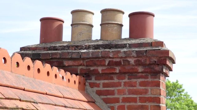 Victorian chimney pots with decorative ridge tiles