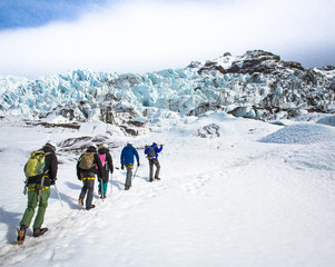 People trekking up glacier