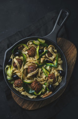Delicious homemade pasta with meatballs and herbs