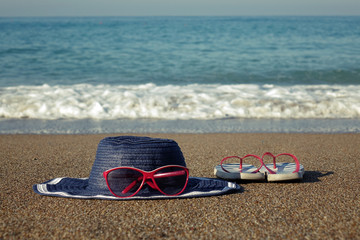 Hat and glasses on the beach. Beach holiday.