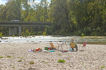 Isarauen, Germany  - AUGUST 14, 2018 - Summer view of Isar river near Munich, the flowing waters...