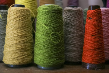 coloured spools of yarn wound onto cones